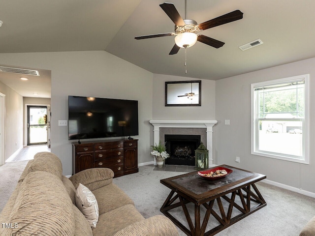 286 Beaver Tavern Dr, Benson, NC 27504 - living room featuring vaulted ceiling, light carpet, ceiling fan, a tiled fireplace, and plenty of natural light