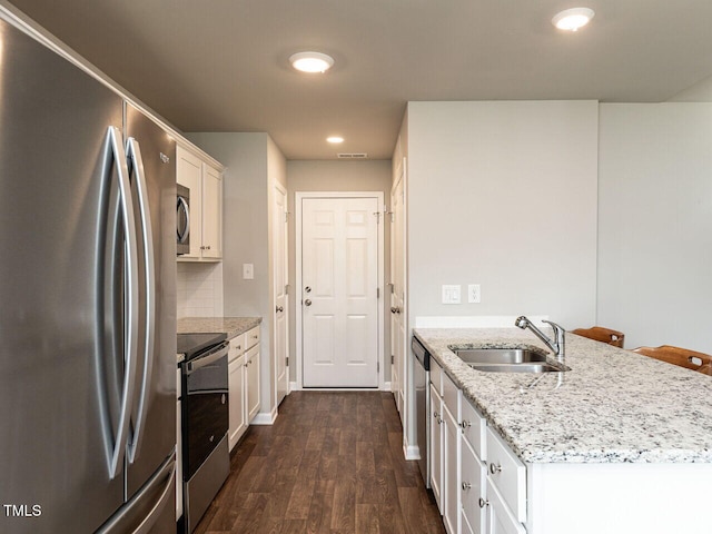 286 Beaver Tavern Dr, Benson, NC 27504 - kitchen with appliances with stainless steel finishes, a sink, a peninsula, dark wood-style flooring, and white cabinets