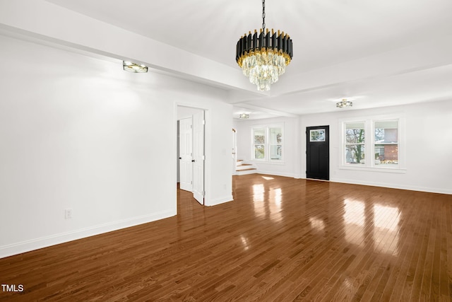 507 Price Ave, Durham, NC 27701 - unfurnished living room with a chandelier, baseboards, stairway, and wood finished floors