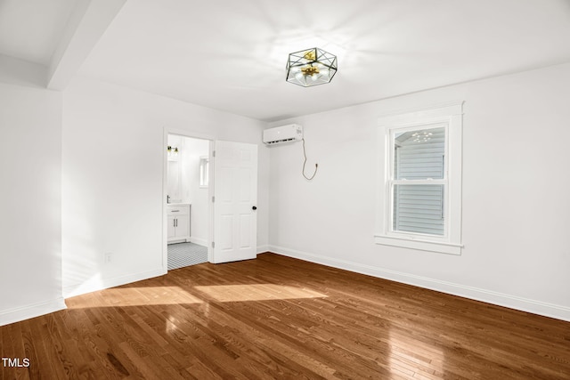 507 Price Ave, Durham, NC 27701 - unfurnished room with a wall mounted AC, wood finished floors, and baseboards