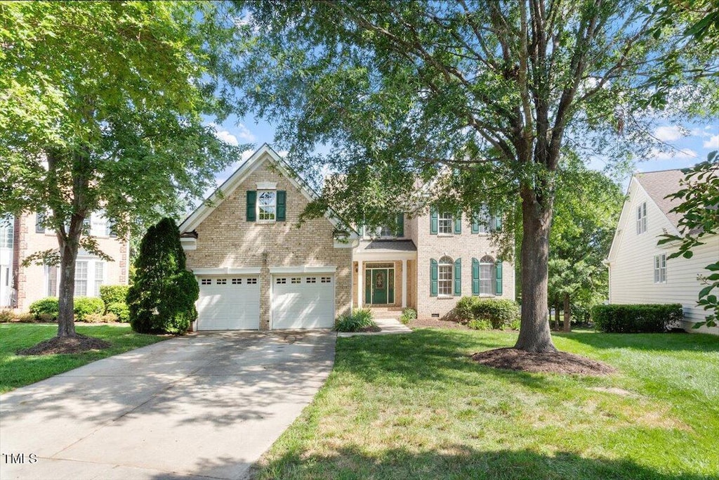 9112 Mission Hills Ct, Raleigh, NC 27617 - view of front of house featuring brick siding, concrete driveway, and a front yard