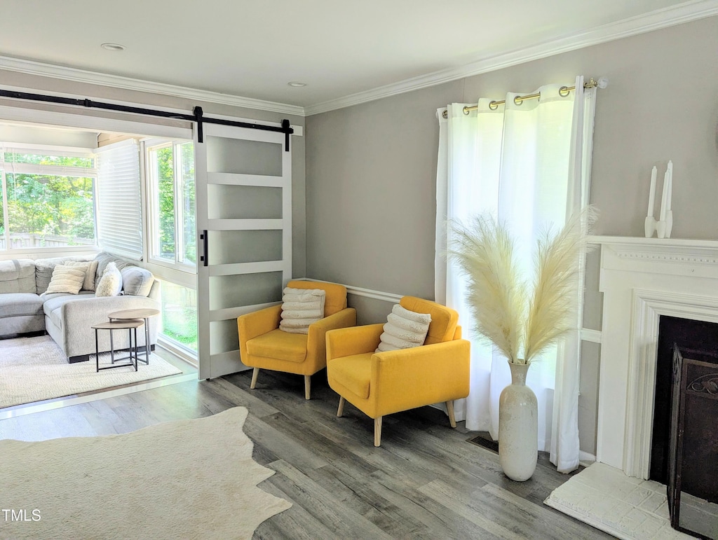 8116 Bentwood Pl, Raleigh, NC 27615 - living area with wood finished floors, ornamental molding, and a barn door