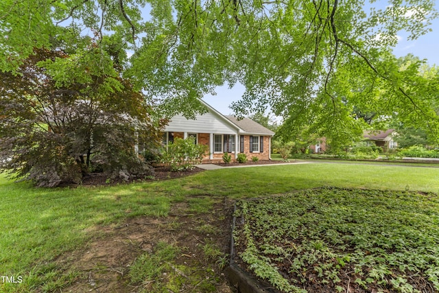 6411 Pondview Ln, Durham, NC 27712 - view of front facade with a front yard and brick siding