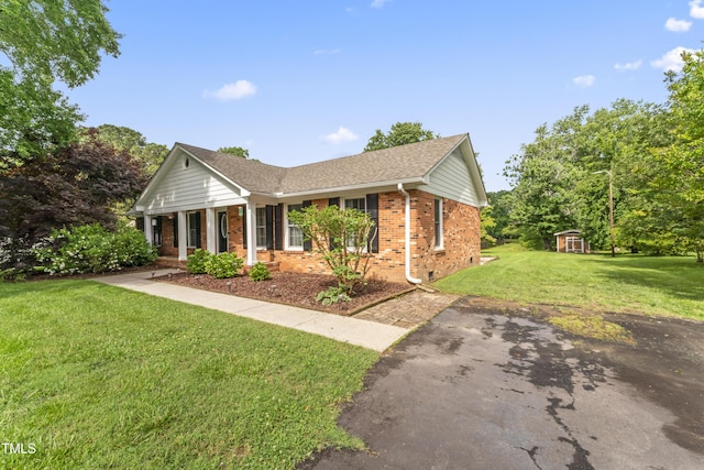 6411 Pondview Ln, Durham, NC 27712 - ranch-style house with brick siding, a front lawn, covered porch, and a shingled roof