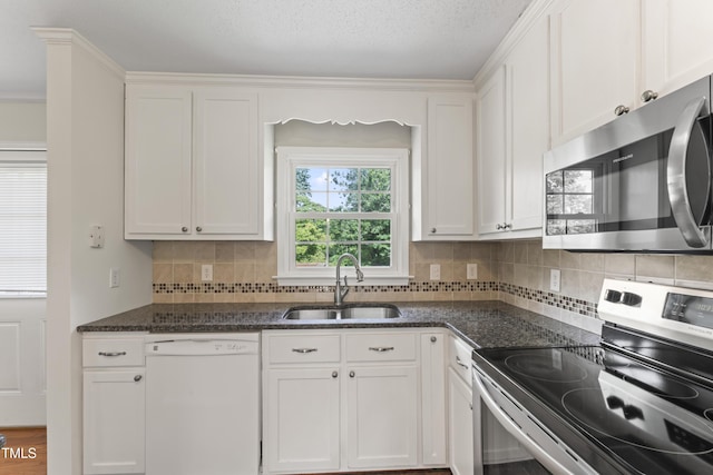 6411 Pondview Ln, Durham, NC 27712 - kitchen featuring stainless steel appliances, a sink, white cabinets, and decorative backsplash