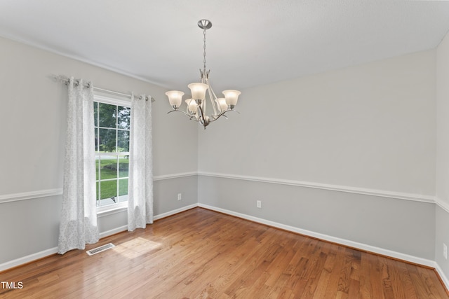 6411 Pondview Ln, Durham, NC 27712 - empty room with a chandelier, wood finished floors, and baseboards