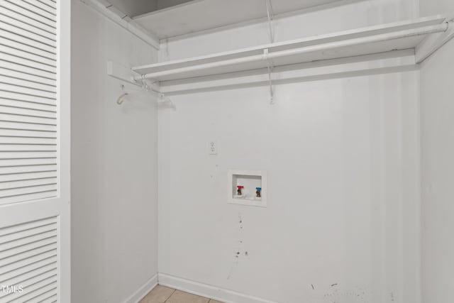 6411 Pondview Ln, Durham, NC 27712 - laundry area with washer hookup, light tile patterned floors, and baseboards
