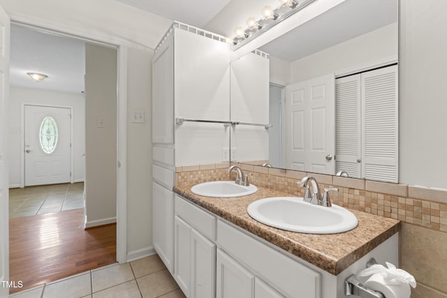 6411 Pondview Ln, Durham, NC 27712 - bathroom with tile patterned flooring, double vanity, a closet, and backsplash