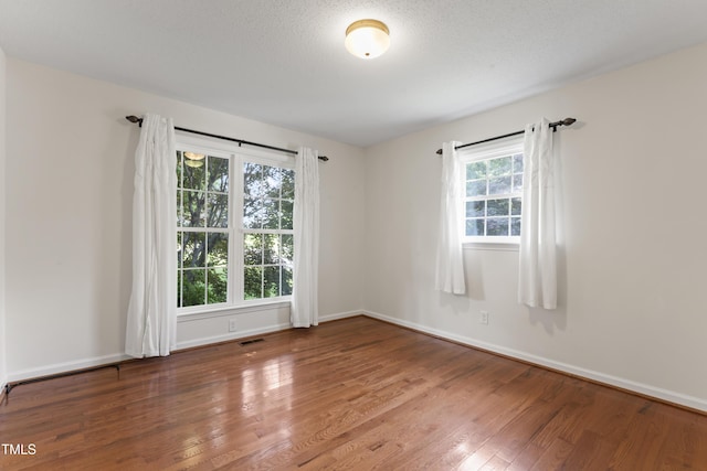 6411 Pondview Ln, Durham, NC 27712 - spare room featuring wood finished floors and baseboards
