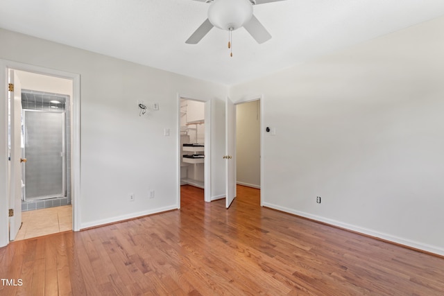 6411 Pondview Ln, Durham, NC 27712 - unfurnished bedroom featuring wood finished floors, a walk in closet, baseboards, a closet, and a ceiling fan