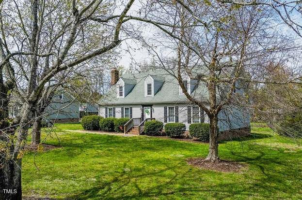 110 W Quail Ridge Rd, Oxford, NC 27565 - new england style home featuring a front lawn and a chimney