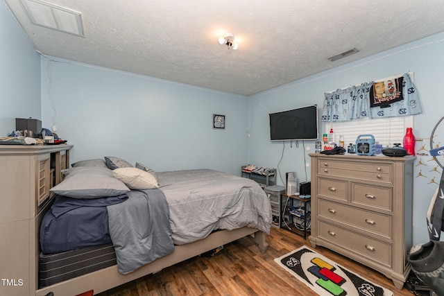 1515 Mack St, Spring Lake, NC 28390 - bedroom with wood finished floors and a textured ceiling