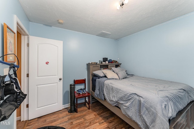 1515 Mack St, Spring Lake, NC 28390 - bedroom featuring wood finished floors, a textured ceiling, and baseboards