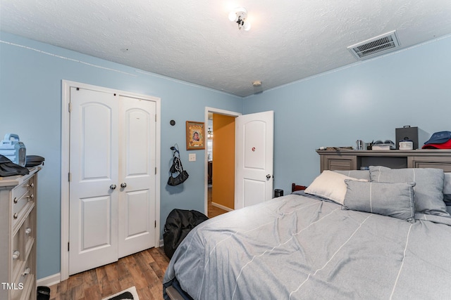 1515 Mack St, Spring Lake, NC 28390 - bedroom featuring wood finished floors, a textured ceiling, and baseboards