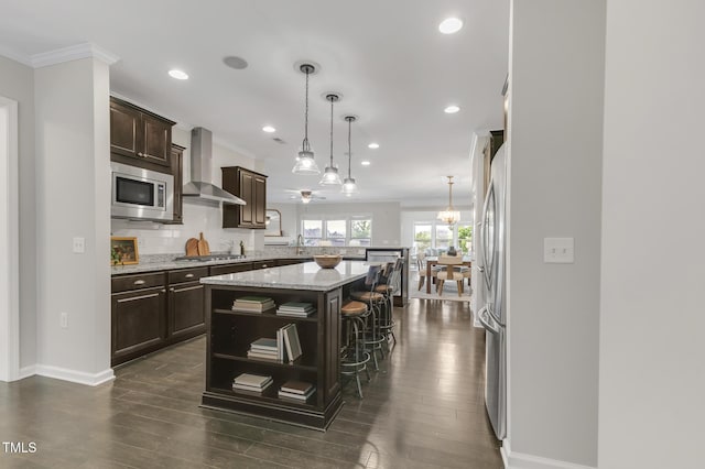 118 Manning Way, Durham, NC 27703 - kitchen featuring wall chimney exhaust hood, stainless steel appliances, a peninsula, ornamental molding, and dark brown cabinets