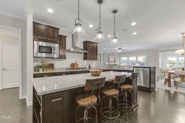 118 Manning Way, Durham, NC 27703 - kitchen with wall chimney exhaust hood, appliances with stainless steel finishes, crown molding, dark brown cabinetry, and a peninsula