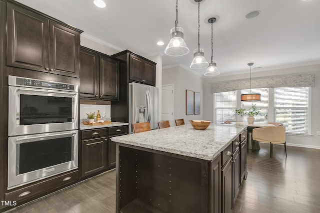 118 Manning Way, Durham, NC 27703 - kitchen with stainless steel appliances, crown molding, pendant lighting, a center island, and light stone counters