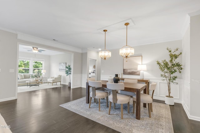 118 Manning Way, Durham, NC 27703 - dining space featuring crown molding, dark wood-type flooring, a chandelier, a wainscoted wall, and a decorative wall