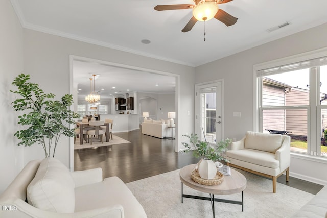 118 Manning Way, Durham, NC 27703 - living room featuring wood finished floors, healthy amount of natural light, a ceiling fan, baseboards, and crown molding