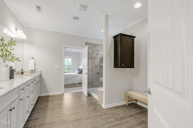118 Manning Way, Durham, NC 27703 - ensuite bathroom featuring double vanity, a shower stall, baseboards, wood finish floors, and crown molding