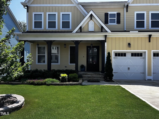 1131 Lowland St, Apex, NC 27523 - view of front of house with a front yard, board and batten siding, driveway, and a garage