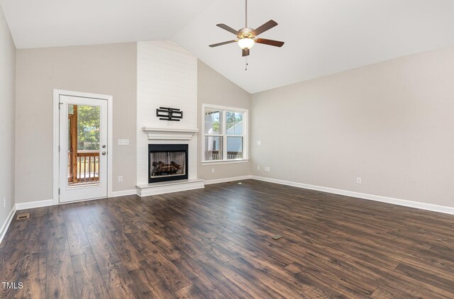 41 Tan Oak Dr, Selma, NC 27576 - unfurnished living room with a ceiling fan, high vaulted ceiling, a large fireplace, dark wood finished floors, and baseboards