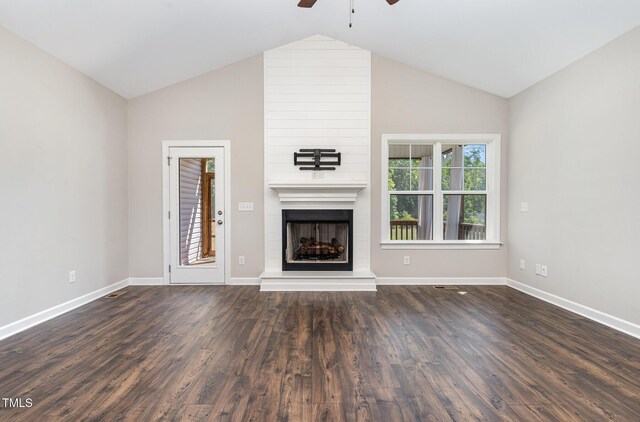 41 Tan Oak Dr, Selma, NC 27576 - unfurnished living room with a ceiling fan, a large fireplace, baseboards, lofted ceiling, and dark wood-style floors