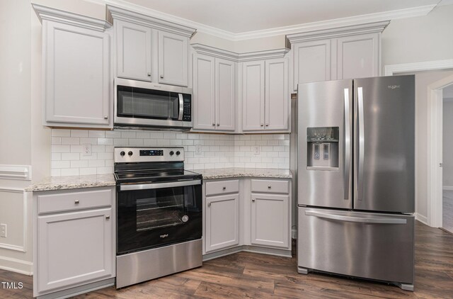 41 Tan Oak Dr, Selma, NC 27576 - kitchen featuring stainless steel appliances, ornamental molding, tasteful backsplash, dark wood-type flooring, and light stone countertops