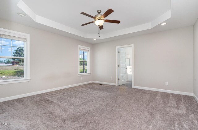 41 Tan Oak Dr, Selma, NC 27576 - empty room featuring a raised ceiling, ceiling fan, recessed lighting, carpet flooring, and baseboards