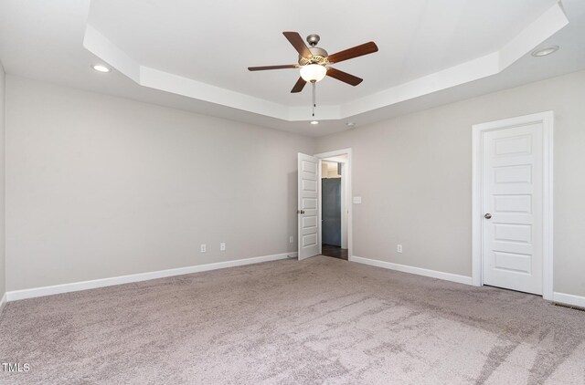 41 Tan Oak Dr, Selma, NC 27576 - empty room featuring a raised ceiling, ceiling fan, recessed lighting, carpet, and baseboards