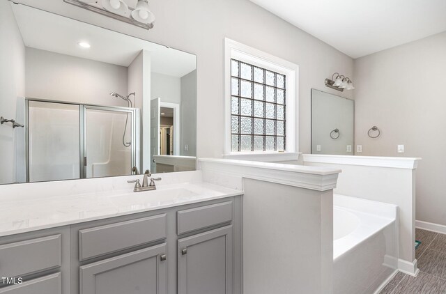 41 Tan Oak Dr, Selma, NC 27576 - bathroom with a stall shower, baseboards, a garden tub, and vanity