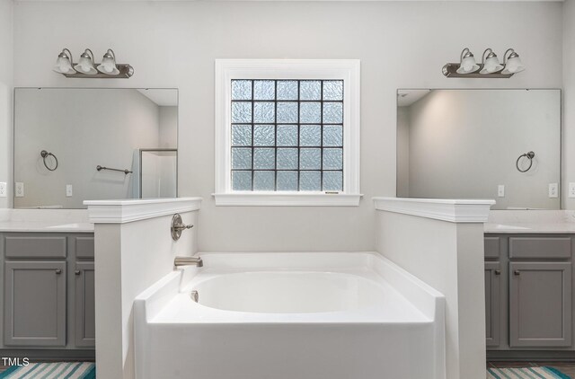 41 Tan Oak Dr, Selma, NC 27576 - bathroom featuring a garden tub, two vanities, and a walk in shower