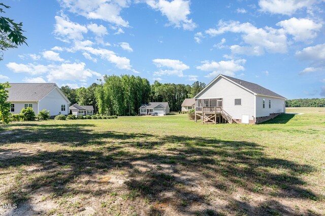 41 Tan Oak Dr, Selma, NC 27576 - view of green lawn featuring stairway and a sunroom