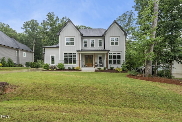 2040 Pleasant Forest Way, Wake Forest, NC 27587 - modern farmhouse style home featuring board and batten siding, a front yard, a standing seam roof, french doors, and metal roof
