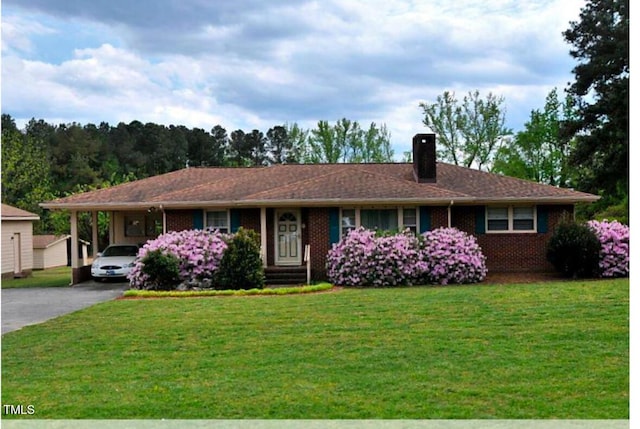 4804 Spring Forest Rd, Raleigh, NC 27616 - single story home with driveway, a chimney, a front lawn, and a carport