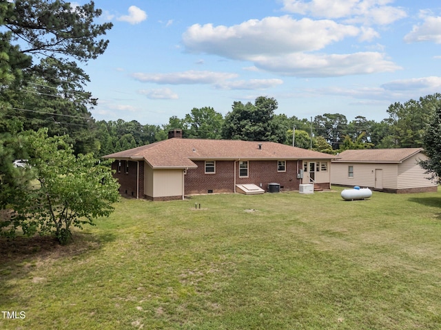 4804 Spring Forest Rd, Raleigh, NC 27616 - rear view of property with brick siding, a chimney, a lawn, and entry steps