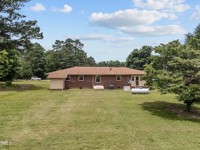 4804 Spring Forest Rd, Raleigh, NC 27616 - rear view of house featuring a lawn, brick siding, a chimney, and crawl space