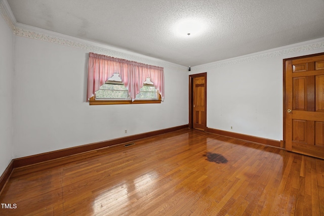 4804 Spring Forest Rd, Raleigh, NC 27616 - spare room with hardwood / wood-style flooring, crown molding, and a textured ceiling