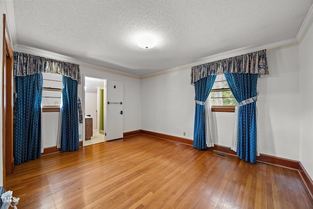 4804 Spring Forest Rd, Raleigh, NC 27616 - unfurnished room featuring light wood-style flooring, a textured ceiling, and ornamental molding