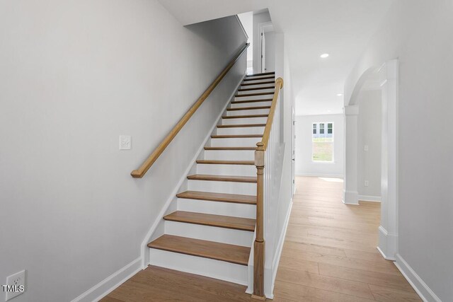 257 N Maple Walk Dr Unit 218, Garner, NC 27529 - staircase with arched walkways, wood finished floors, baseboards, and recessed lighting