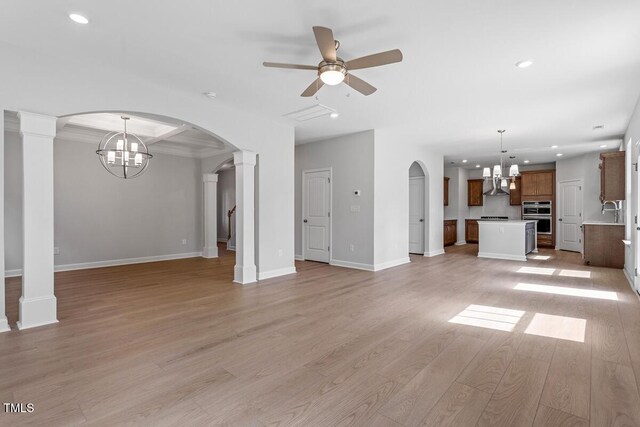 257 N Maple Walk Dr Unit 218, Garner, NC 27529 - unfurnished living room with a chandelier, arched walkways, recessed lighting, light wood-style flooring, and a ceiling fan