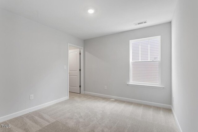 257 N Maple Walk Dr Unit 218, Garner, NC 27529 - spare room featuring baseboards and light carpet