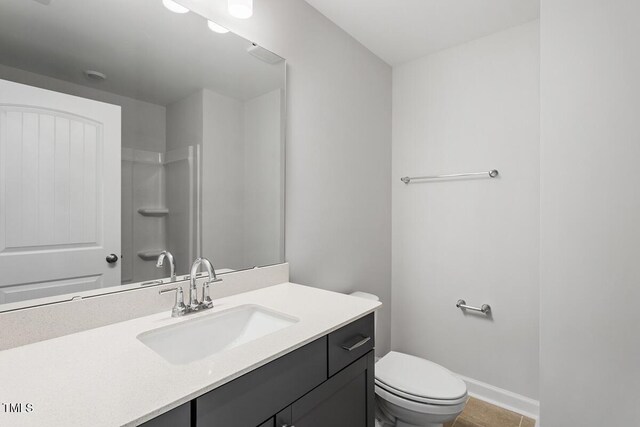 257 N Maple Walk Dr Unit 218, Garner, NC 27529 - bathroom featuring vanity, toilet, and baseboards