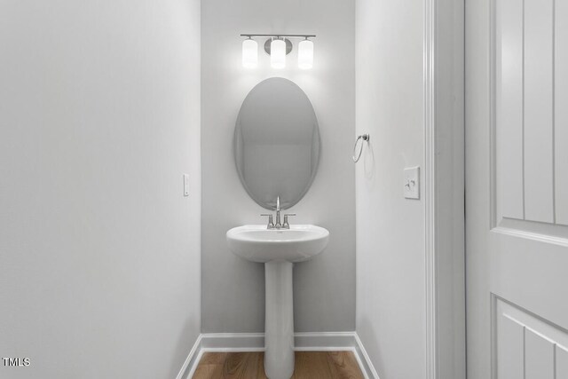 257 N Maple Walk Dr Unit 218, Garner, NC 27529 - bathroom with baseboards and wood finished floors
