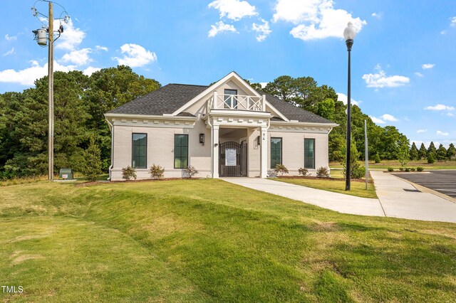 257 N Maple Walk Dr Unit 218, Garner, NC 27529 - view of front of property featuring a front lawn, a shingled roof, and brick siding