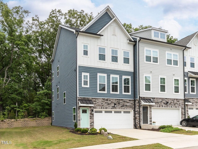 2008 Van Hook Ln, Apex, NC 27502 - townhome / multi-family property with a garage, concrete driveway, stone siding, board and batten siding, and a front lawn