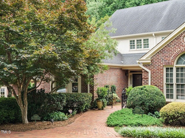 3339 Ridgecrest Ct, Raleigh, NC 27607 - view of front of house featuring brick siding, a shingled roof, and stucco siding
