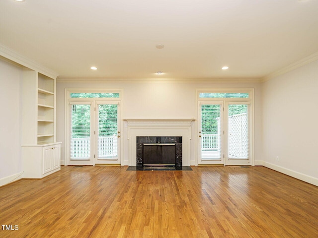 3339 Ridgecrest Ct, Raleigh, NC 27607 - unfurnished living room featuring ornamental molding, light wood-style floors, a fireplace, healthy amount of natural light, and recessed lighting