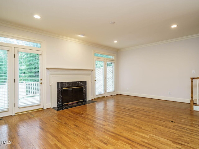 3339 Ridgecrest Ct, Raleigh, NC 27607 - unfurnished living room featuring wood finished floors, ornamental molding, a premium fireplace, and recessed lighting