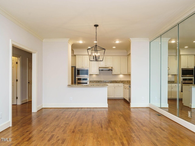 3339 Ridgecrest Ct, Raleigh, NC 27607 - kitchen with stainless steel appliances, a chandelier, ornamental molding, under cabinet range hood, and wood finished floors
